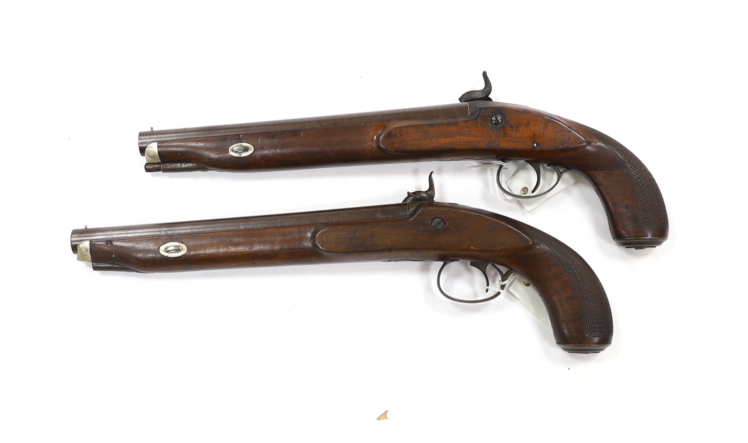 A pair of 12 bore percussion pistols converted from percussion sporting guns, round twist barrels, locks stamped G. Day, iron mounts with nickel fore-end caps and chequered grips